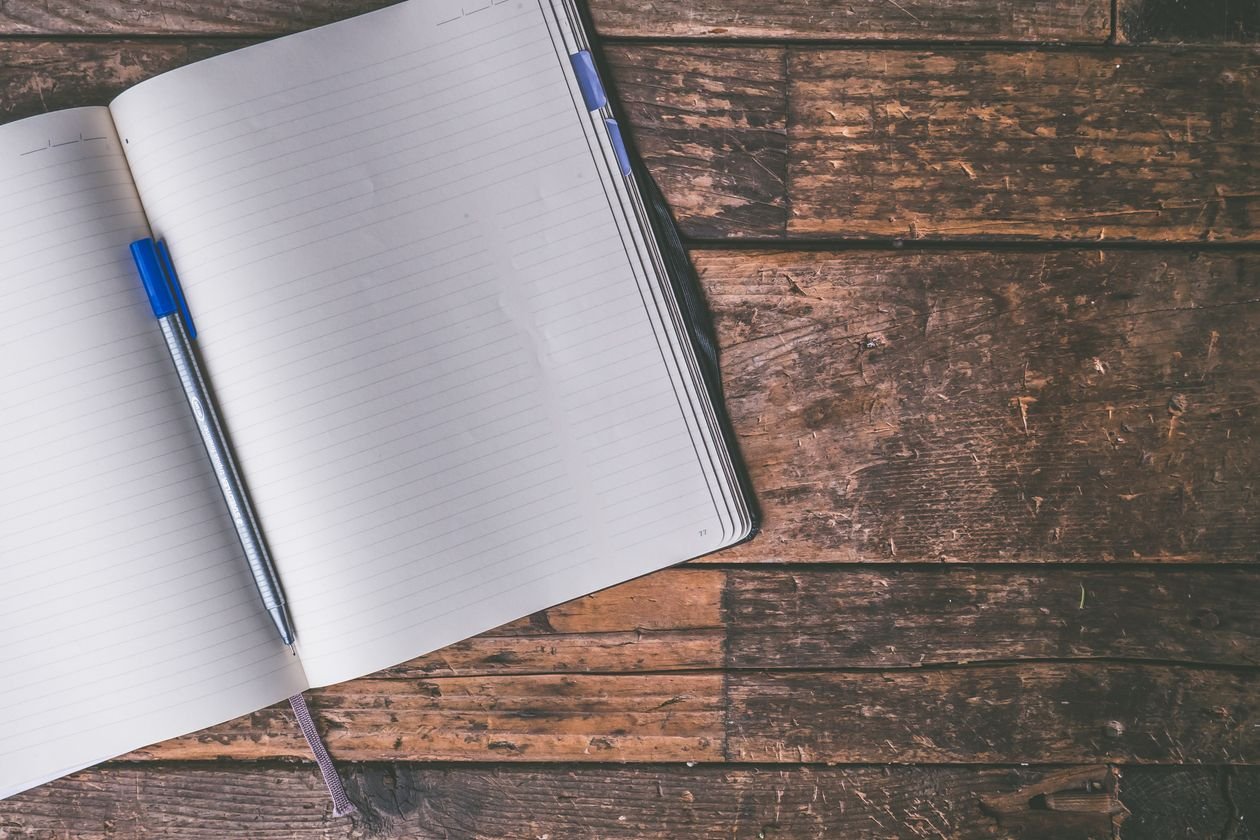 Writing in a journal at a table